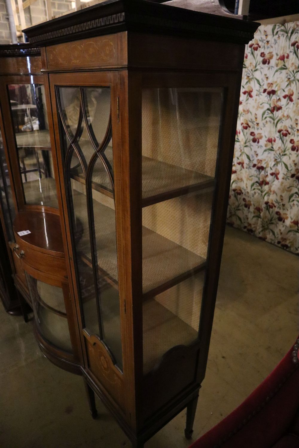 An Edwardian marquetry inlaid mahogany bow fronted display cabinet